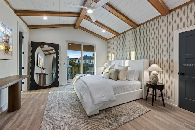 bedroom with access to outside, lofted ceiling with beams, ceiling fan, and light hardwood / wood-style floors