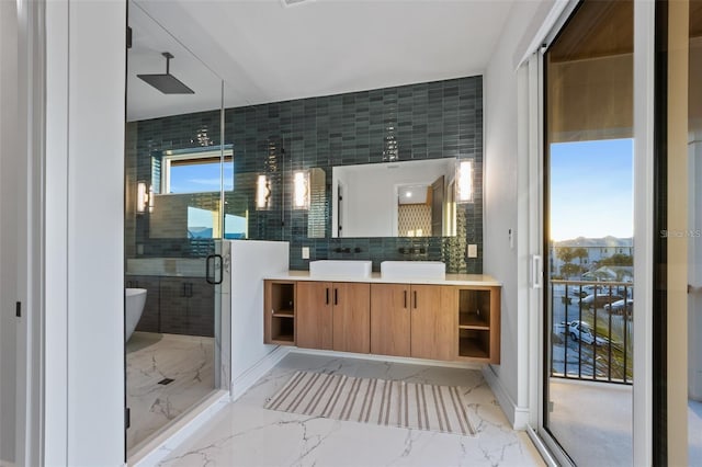 bathroom featuring vanity, a mountain view, a shower with shower door, and tasteful backsplash