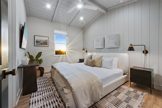 bedroom with wood-type flooring, lofted ceiling with beams, ceiling fan, and wood ceiling