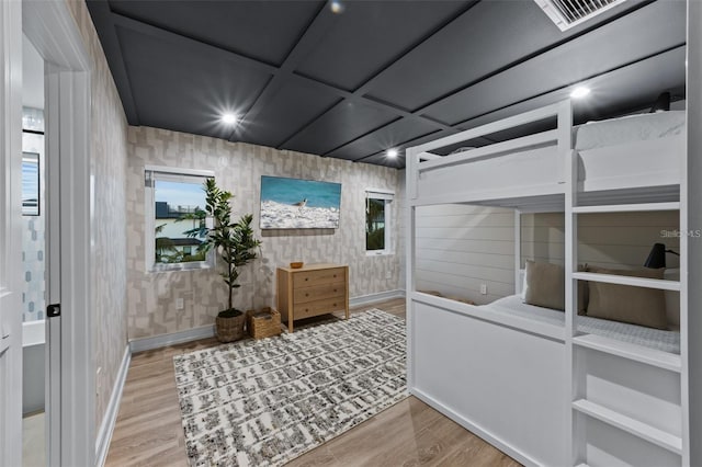 bedroom with wood-type flooring and coffered ceiling