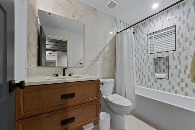 full bathroom featuring vanity, shower / bathtub combination with curtain, toilet, and tile walls