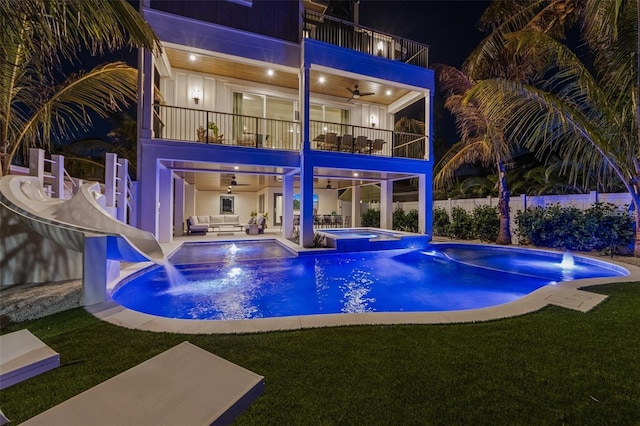 view of swimming pool featuring an in ground hot tub, an outdoor hangout area, pool water feature, ceiling fan, and a patio