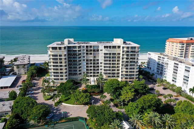 aerial view with a water view and a beach view