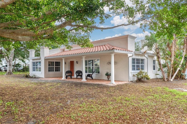 mediterranean / spanish-style home featuring a patio area