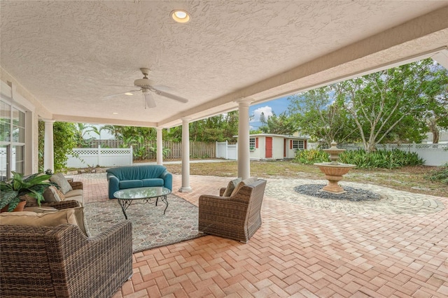 view of patio / terrace with ceiling fan and an outdoor structure