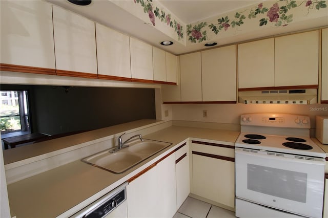 kitchen featuring white appliances, sink, and light tile patterned floors