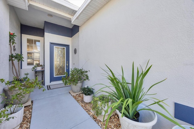 entrance to property featuring stucco siding