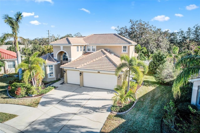 mediterranean / spanish-style home with a front lawn and a garage