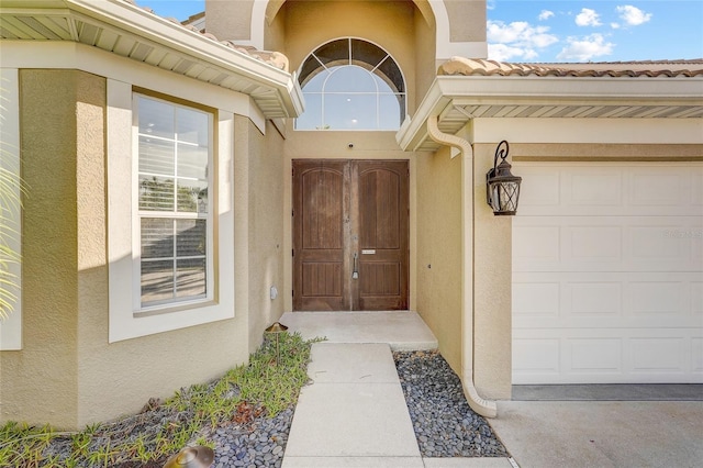 view of exterior entry featuring a garage