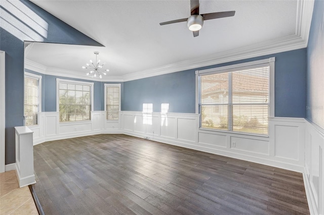 unfurnished room featuring ceiling fan with notable chandelier, wood-type flooring, crown molding, and a wealth of natural light