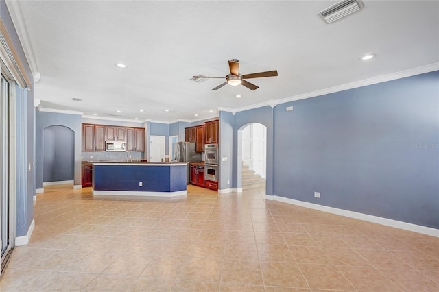 kitchen featuring a center island, light tile patterned flooring, ornamental molding, and appliances with stainless steel finishes