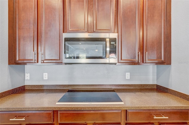 kitchen with black electric cooktop