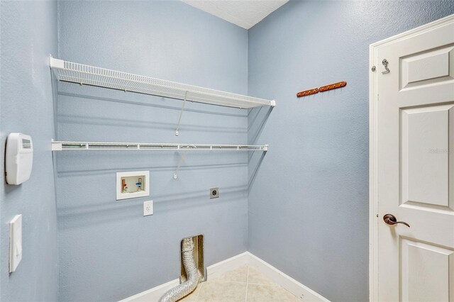 laundry room featuring hookup for an electric dryer, tile patterned floors, and washer hookup