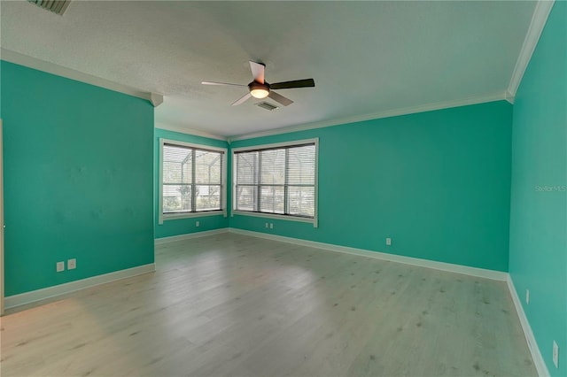 empty room with a textured ceiling, light hardwood / wood-style floors, ceiling fan, and ornamental molding