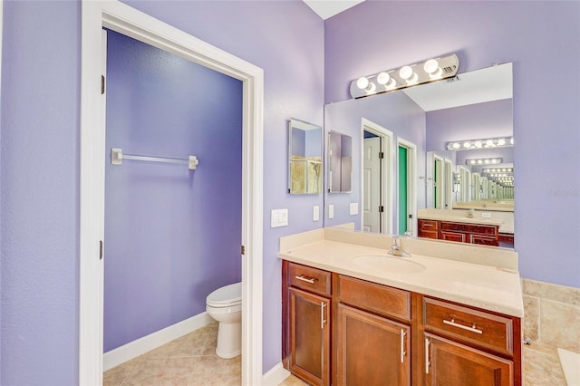 bathroom with tile patterned floors, vanity, and toilet