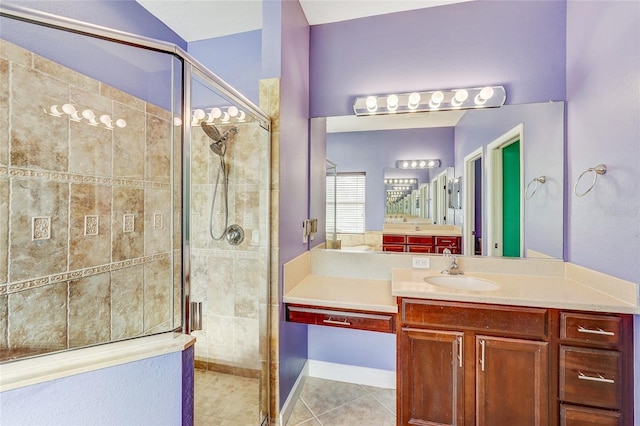 bathroom with tile patterned floors, vanity, and a shower with shower door