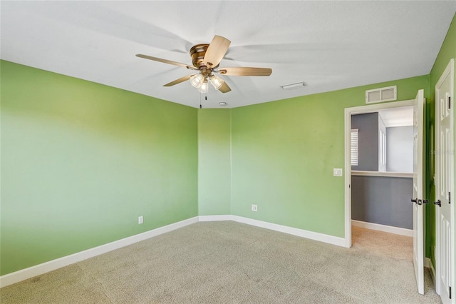 empty room with ceiling fan and light colored carpet