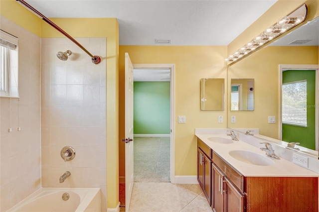 bathroom with vanity, tiled shower / bath combo, and tile patterned floors