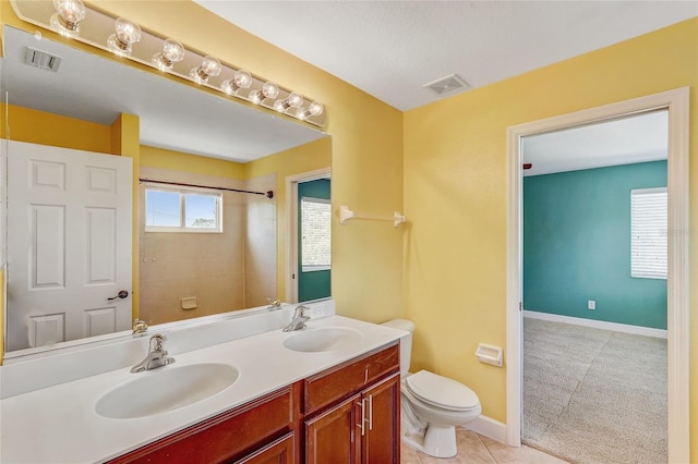 bathroom with tile patterned floors, vanity, and toilet