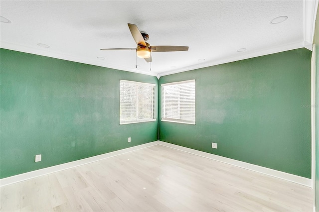 spare room featuring light hardwood / wood-style floors, ceiling fan, and ornamental molding