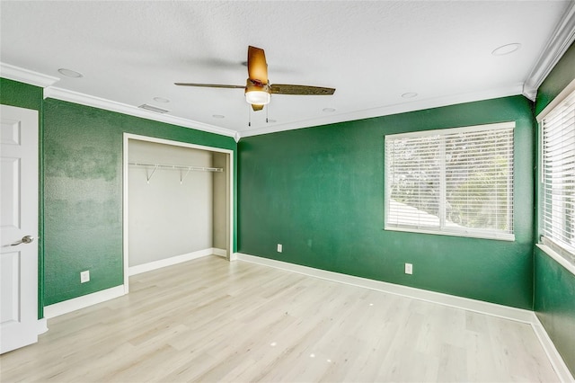 unfurnished bedroom with light hardwood / wood-style flooring, ceiling fan, ornamental molding, a textured ceiling, and a closet