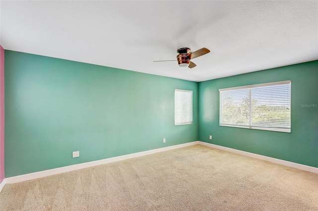 carpeted empty room featuring ceiling fan