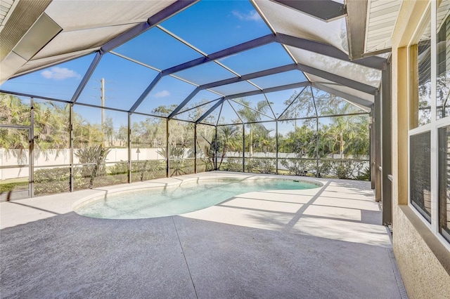 view of pool featuring a patio area and glass enclosure