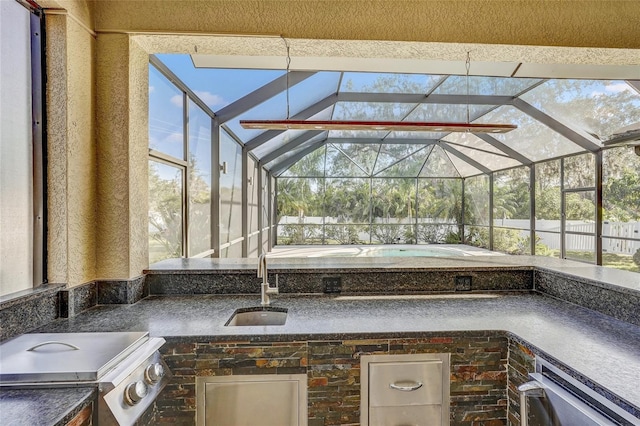 view of patio / terrace featuring a lanai and sink