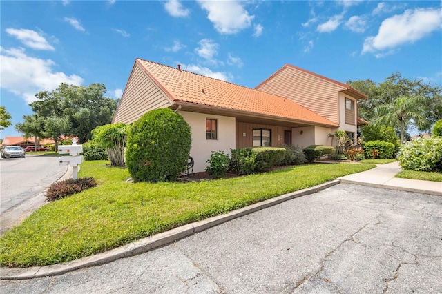 view of side of property with a lawn