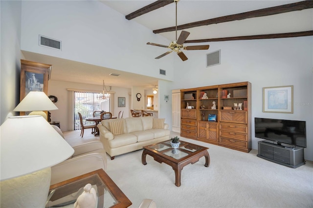 carpeted living room with a towering ceiling, ceiling fan with notable chandelier, and beam ceiling