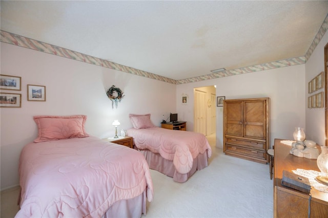 carpeted bedroom featuring a textured ceiling