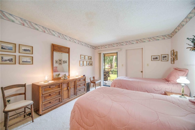 bedroom featuring light carpet, access to outside, and a textured ceiling