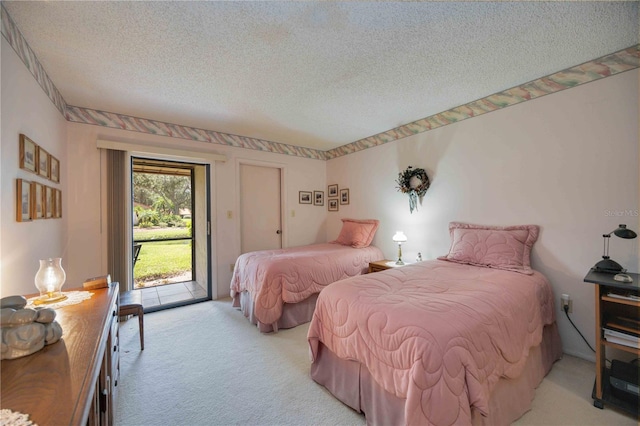 carpeted bedroom with access to exterior and a textured ceiling