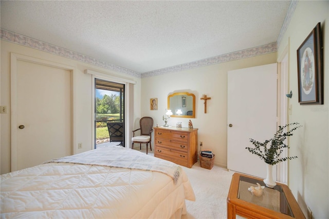 carpeted bedroom featuring access to outside and a textured ceiling