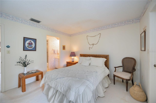 carpeted bedroom with ensuite bathroom