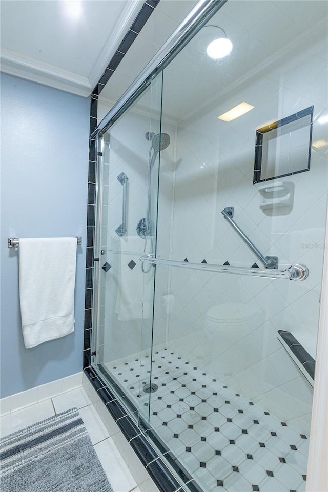 bathroom with tile patterned floors, crown molding, and an enclosed shower