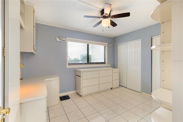 bathroom featuring ceiling fan, tile patterned flooring, and a textured ceiling