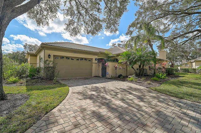 view of front of house featuring a front yard and a garage