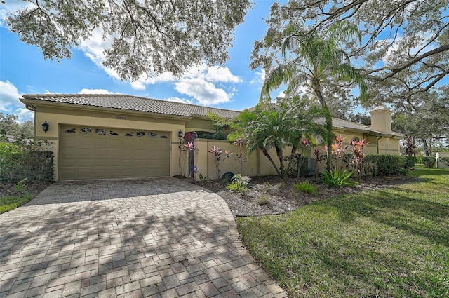 view of front of house with a garage and a front lawn