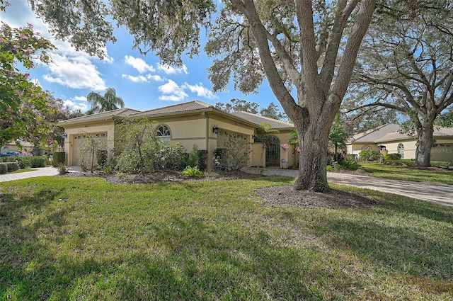 view of front of house with a front yard and a garage