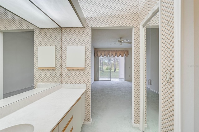 bathroom with ceiling fan and sink