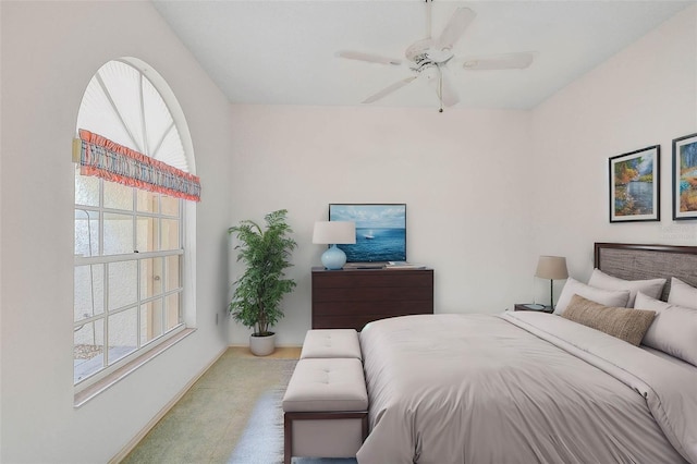 bedroom with multiple windows and ceiling fan