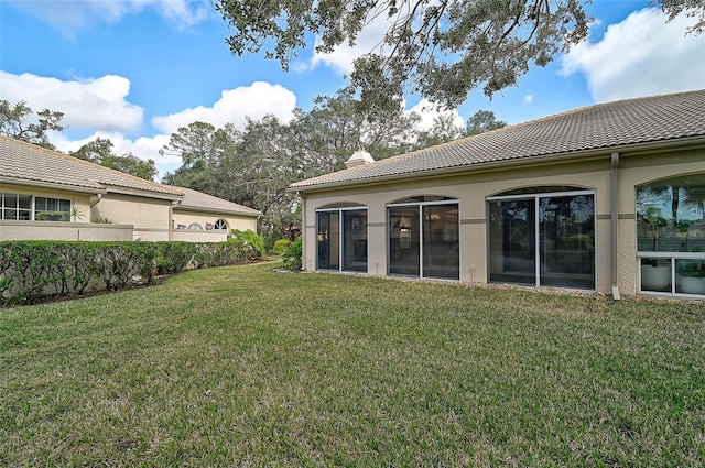 back of property featuring a lawn