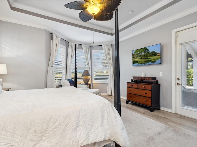 bedroom with access to exterior, a raised ceiling, ceiling fan, crown molding, and light hardwood / wood-style floors