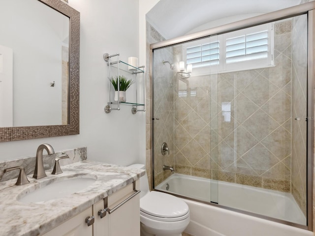 full bathroom featuring shower / bath combination with glass door, vanity, and toilet