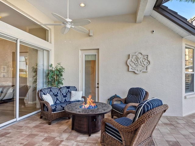 view of patio featuring an outdoor fire pit and ceiling fan