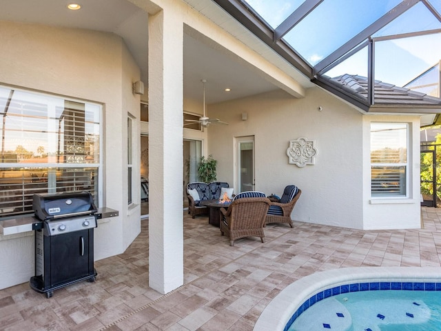 view of patio with grilling area, ceiling fan, a swimming pool, and glass enclosure