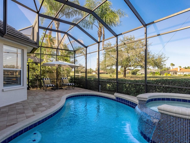 view of pool with glass enclosure, a patio area, and an in ground hot tub