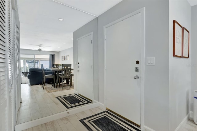 entrance foyer with ceiling fan and light hardwood / wood-style floors