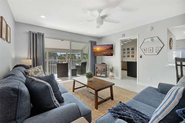 living room with ceiling fan and light wood-type flooring